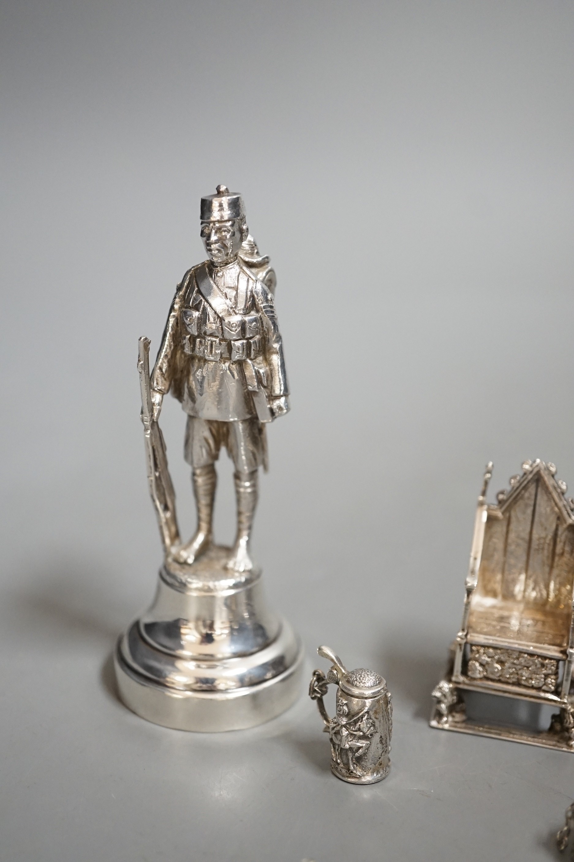 A group of novelty miniature silver items to include a sword, a solider by Goldsmiths & Silversmiths Co Ltd, London, 1930, 10.5cm, a throne, a matador figure, etc.